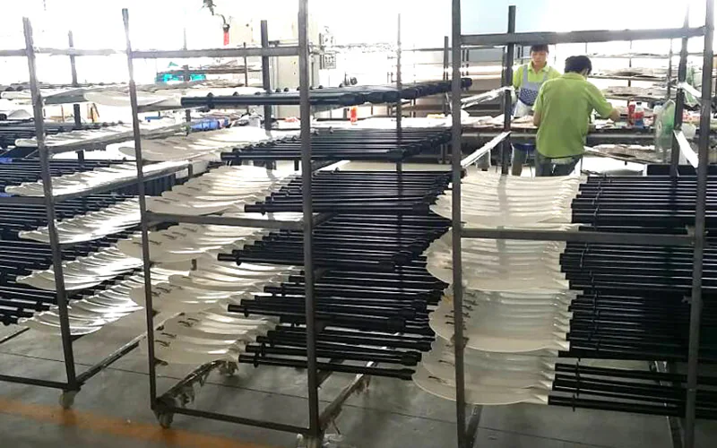 Paddle components organized on production racks inside the workshop
