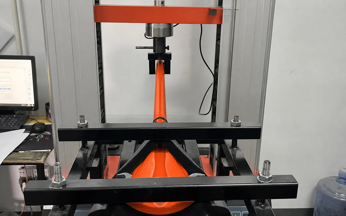 Orange kayak paddle secured in Vision Sports testing equipment