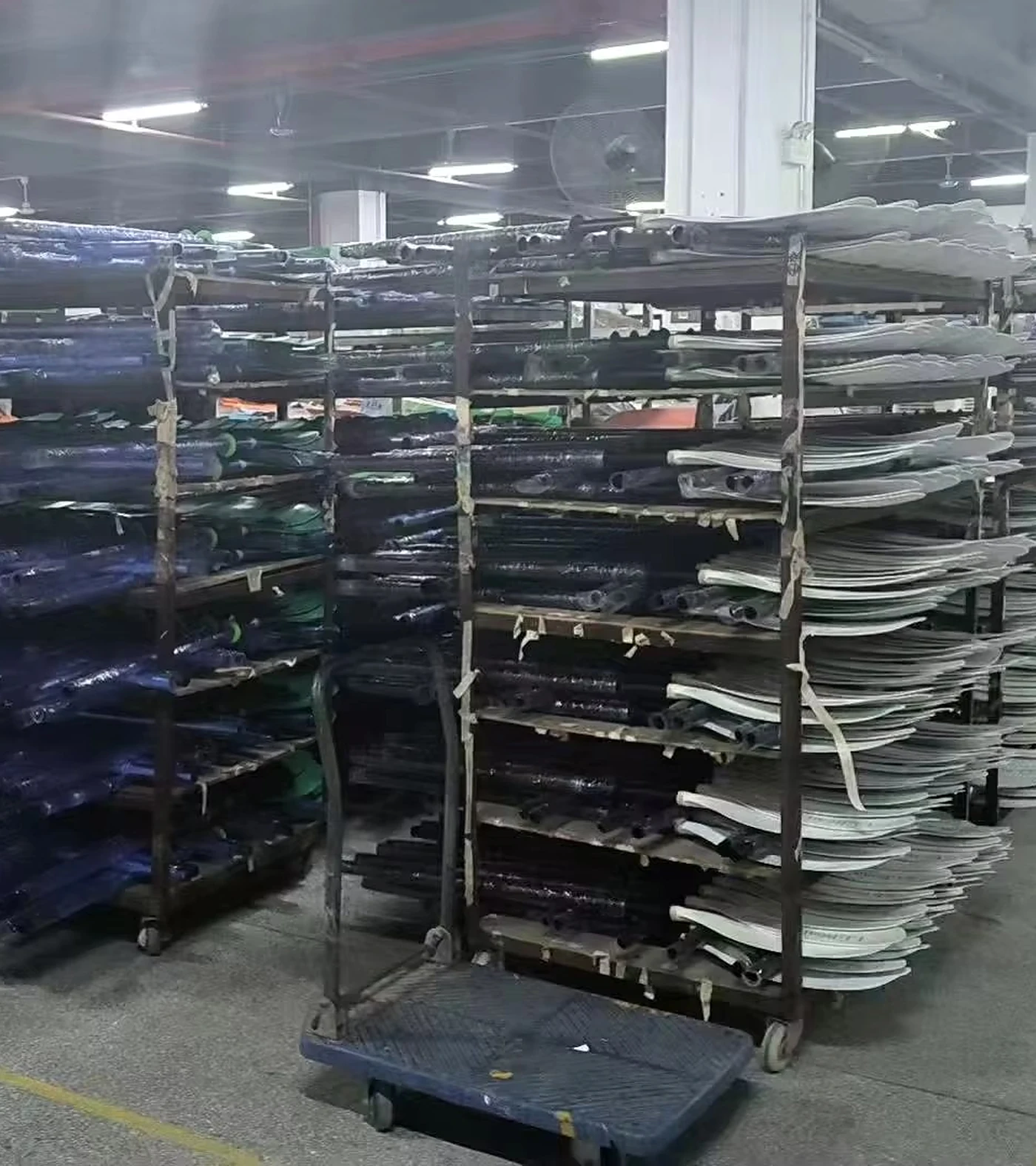 Paddle blade and shaft components organized on factory racks