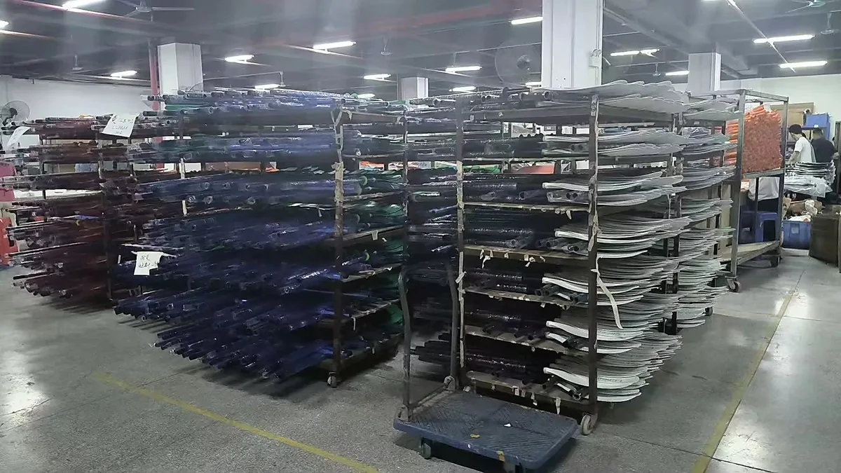 Paddle shafts and blade components organized on production racks in the Huizhou workshop